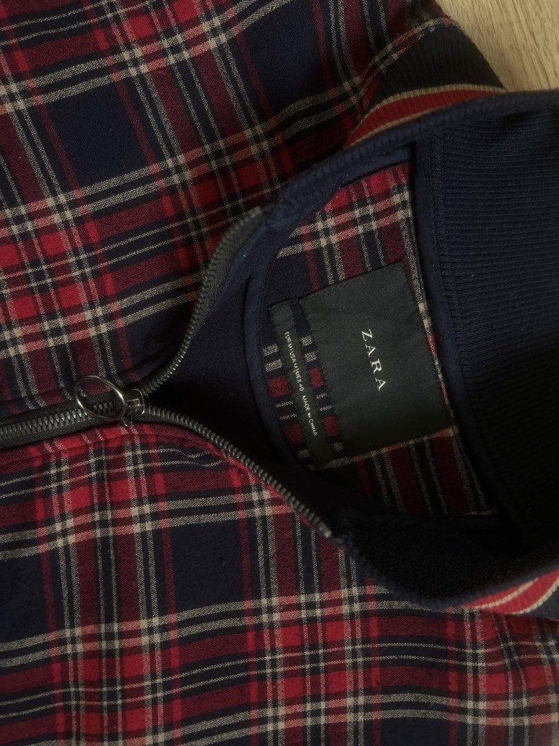 Zara Plaid Bomber Jacket (Category: Coats, Jackets and Outerwear) located in Quezon City. Submitted by rie.berns67 (Listing ID 1455535973, Image 3). Description: Navy and red plaid bomber jacket from Zara. Zip-up front with a ring pull. Ribbed collar, cuffs, and hem. Zipper pocket on the sleeve. - Length: 26 inches - Width: 23 inches Loc: QC.