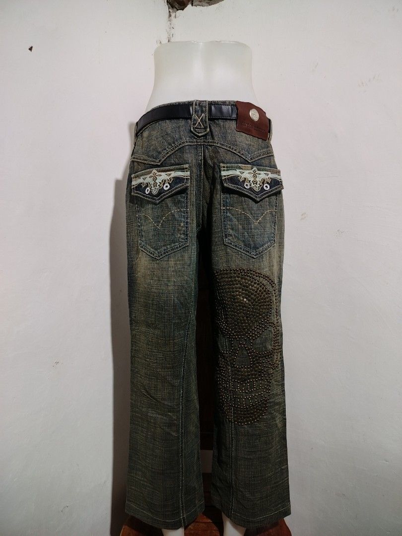 Antik Denim Studded Skull Jeans (Category: Jeans) located in Clarin. Submitted by thriftfinds.2026 (Listing ID 1455794698, Image 2). Description: - Cool Antik Denim jeans - Large studded skull design on right leg - Studded detailing on front pockets - Distressed look with rips - Unique back pocket embroidery - Belt included - Flare leg style.