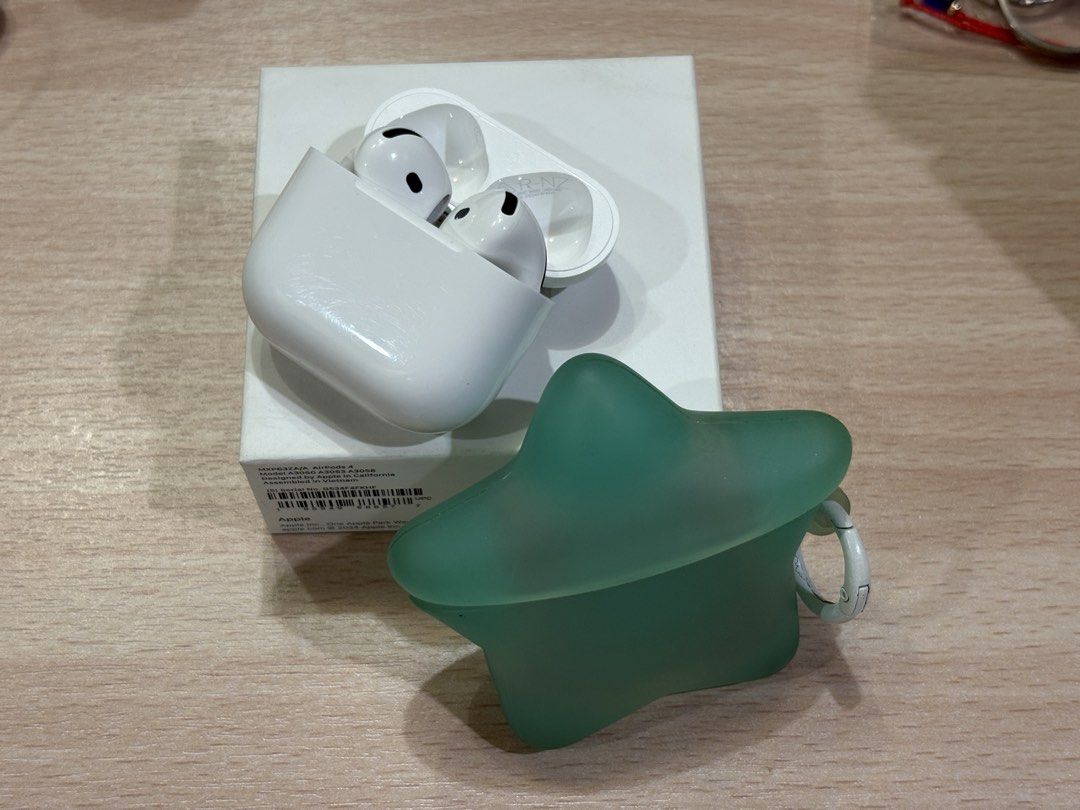 Apple AirPods 4 with box & Star Case (Category: Earphones) located in Rodriguez. Submitted by 404moni (Listing ID 1455785306, Image 1). Description: - Apple AirPods 4 (No ANC) - Original charging case included - With warranty - Good Condition - With: star-shaped silicone case with keychain loop - Original box included - Feel free to ask me any questions! I bought it earlier this year (2026) RFS: Need more funds and barely used..