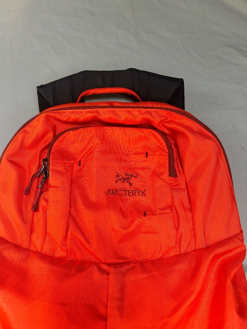 Arc'teryx Cambie Orange Backpack (Category: Backpacks) located in Calaca. Submitted by thriftstar1 (Listing ID 1455775042, Image 2). Description: Orange Arc'teryx backpack. Has a main compartment and a front zip pocket. Padded shoulder straps and back panel for comfort. Great for day trips or travel. Lightweight and durable material..