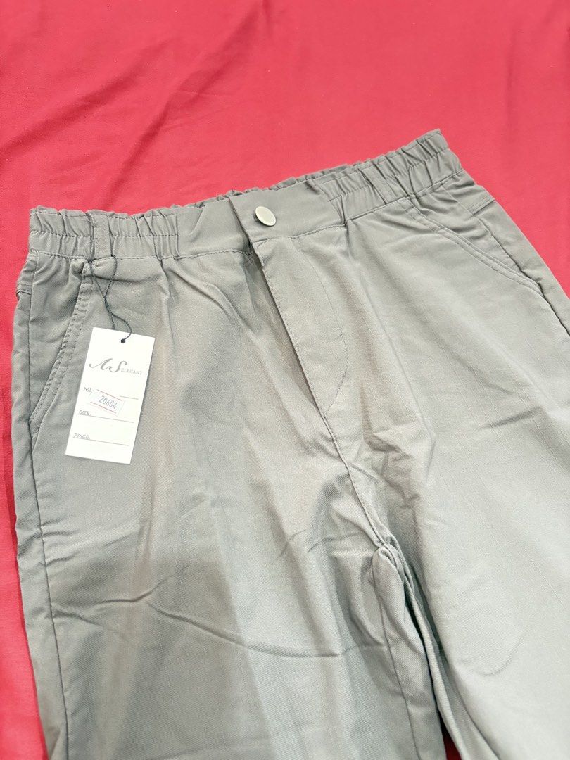 AS Elegant Grey Elastic Waist Pants (Category: Other Bottoms) located in Calamba. Submitted by tripleceedoubletwo (Listing ID 1455724209, Image 3). Description: Comfy grey pants with elastic waistband, button/zip closure, and pockets. Brand new with tag. Perfect for casual outfits! Waist:24-28 in Length: 32 in.