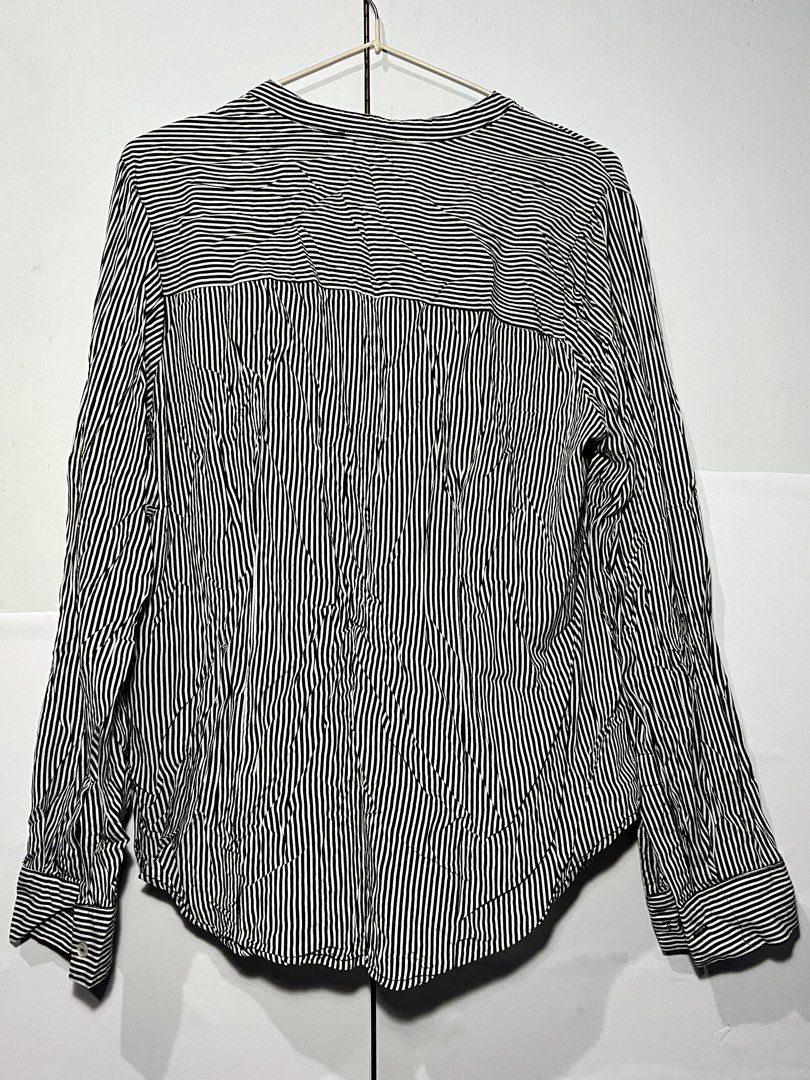 Atmosphere Black & White Striped Long Sleeve Blouse (Category: Longsleeves) located in Quezon City. Submitted by ishaan1423 (Listing ID 1455706417, Image 2). Description: Atmosphere black and white vertical striped long sleeve blouse in UK size 16 (US 12). Features a flattering V-neck band collar, button-front closure, and roll-tab sleeves for versatile styling. Lightweight and comfortable, perfect for office wear, casual outfits, or smart casual