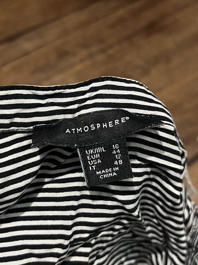 Atmosphere Black & White Striped Long Sleeve Blouse (Category: Longsleeves) located in Quezon City. Submitted by ishaan1423 (Listing ID 1455706417, Image 3). Description: Atmosphere black and white vertical striped long sleeve blouse in UK size 16 (US 12). Features a flattering V-neck band collar, button-front closure, and roll-tab sleeves for versatile styling. Lightweight and comfortable, perfect for office wear, casual outfits, or smart casual