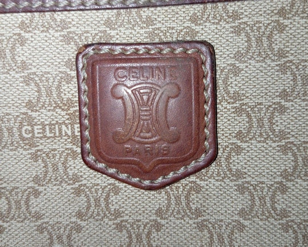 Authentic Celine Madacam Monogram Clutch (Category: Luxury Bags & Wallets) located in Andop. Submitted by source8600 (Listing ID 1455783459, Image 3). Description: vintage Celine Macadam monogram clutch bag features a beige coated canvas body with brown leather trim and an integrated wrist strap..