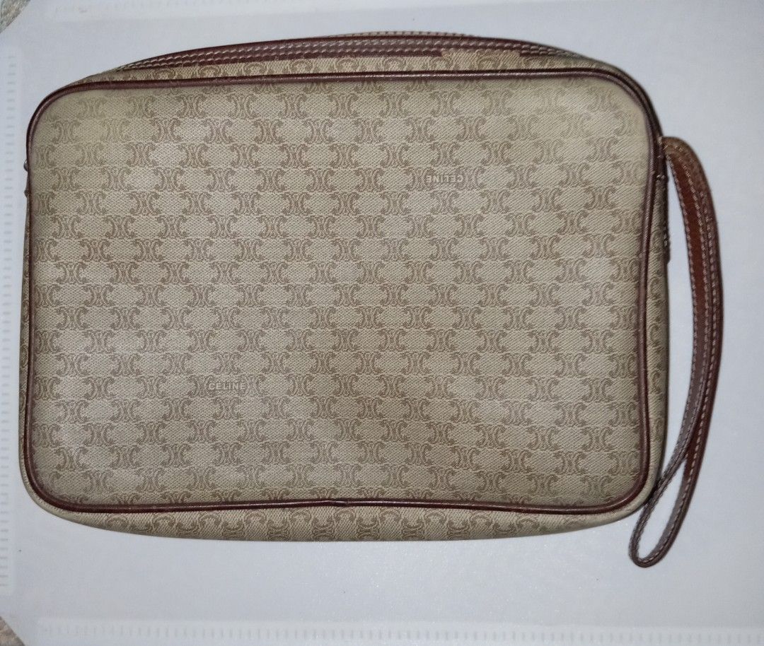 Authentic Celine Madacam Monogram Clutch (Category: Luxury Bags & Wallets) located in Andop. Submitted by source8600 (Listing ID 1455783459, Image 2). Description: vintage Celine Macadam monogram clutch bag features a beige coated canvas body with brown leather trim and an integrated wrist strap..