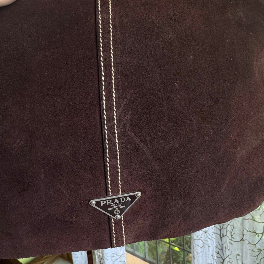 Authentic Prada suede hobo bag (Category: Luxury Bags & Wallets) located in Quezon City. Submitted by jhaediah (Listing ID 1455675033, Image 2). Description: ‼️LOW PRICE ALERT‼️ Prada suede hobo bag Perfect for y2k girlies In very good condition With few scratches only First to pay basis ✨.