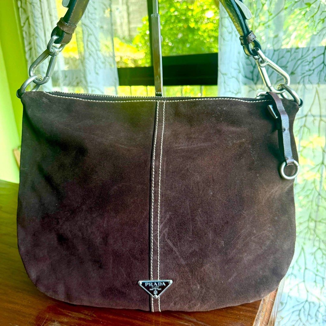 Authentic Prada suede hobo bag (Category: Luxury Bags & Wallets) located in Quezon City. Submitted by jhaediah (Listing ID 1455675033, Image 1). Description: ‼️LOW PRICE ALERT‼️ Prada suede hobo bag Perfect for y2k girlies In very good condition With few scratches only First to pay basis ✨.