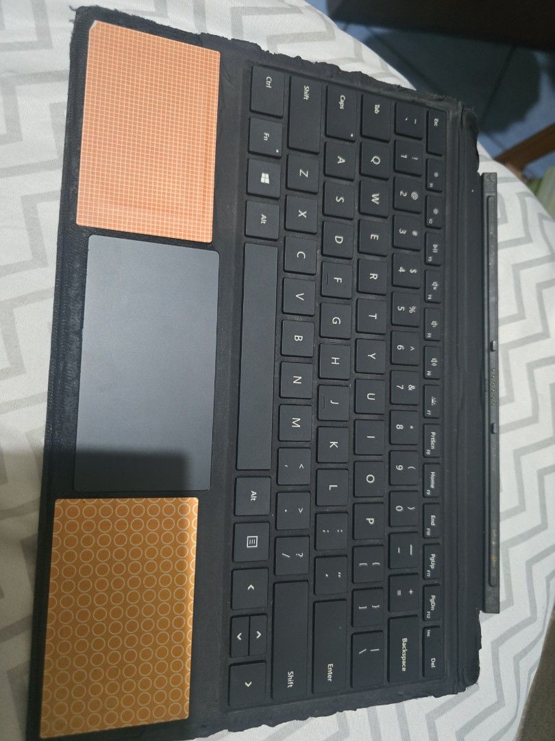 Black Keyboard Cover for Microsoft Surface Pro (Category: Computer Keyboard) located in Pasig City. Submitted by aangelic (Listing ID 1455761109, Image 1). Description: - Black keyboard cover - Compatible with Microsoft Surface Pro (likely) - Minor cosmetic imperfections: small red and green specks on surface - Visible wear on edges - Sold as is.