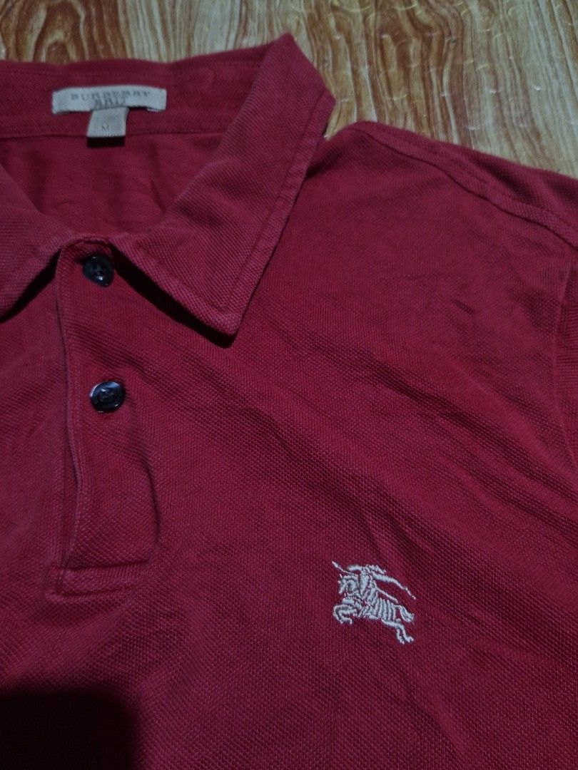Burberry Red Polo Shirt Size M (Category: Tshirts & Polo Shirts ) located in Cebu City. Submitted by marckythrift (Listing ID 1455683990, Image 2). Description: -Ganyan talaga kulay nya dark red - Color rate 9.8 or better - Classic red Burberry polo shirt - Features iconic embroidered Burberry knight logo - Made in Turkey - 100% cotton - Tagged size M - Ideal for casual wear.