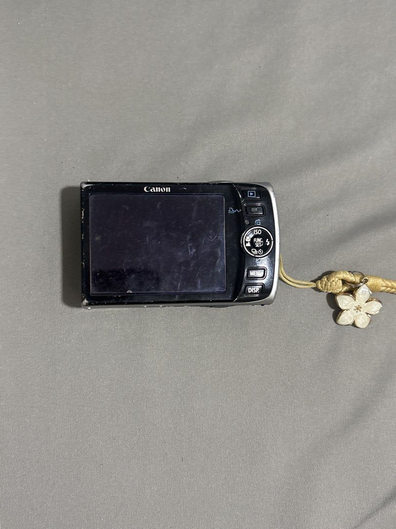 Canon PowerShot SD870 IS Digital Camera (Category: Cameras) located in Caloocan City. Submitted by theobnsacct (Listing ID 1455827129, Image 2). Description: - Canon PowerShot SD870 IS Digital Camera - 8.0 Megapixels for clear photos with a touch of nostalgia - 3.8x Optical Zoom to get closer - Comes with a cute flower charm strap, battery, charger, and case - Ideal for retro photography - Issue: screenburn and scratches - Ask me any questions or