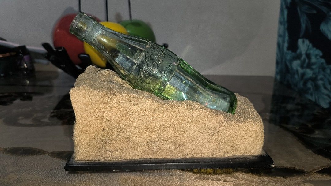 CCBPI 20 Years and Beyond 2001 (Category: Vintage Collectibles) located in Bulacan. Submitted by tripledouble532 (Listing ID 1455745343, Image 3). Description: Coca-Cola Philippines CCBPI 20 Years and Beyond 2001 Beach Sand Base w/ Bottle. Now 45 years and counting. Plaque says that during World War II, Coca-Cola was bottled for U.S. Army troops in Cebu. The bottle is a genuine glass Coca-Cola contour bottle, and the markings visible on the front