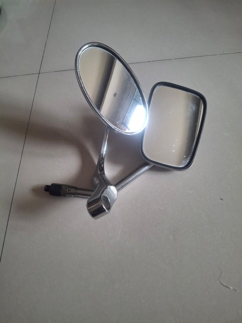 Chrome Motorcycle Mirrors Pair (Category: Mirrors) located in Lipa City. Submitted by theretromanph (Listing ID 1455690241, Image 1). Description: - Classic chrome motorcycle mirrors - Fits handlebars - One rectangular mirror, one oval mirror - Minor signs of wear on chrome.