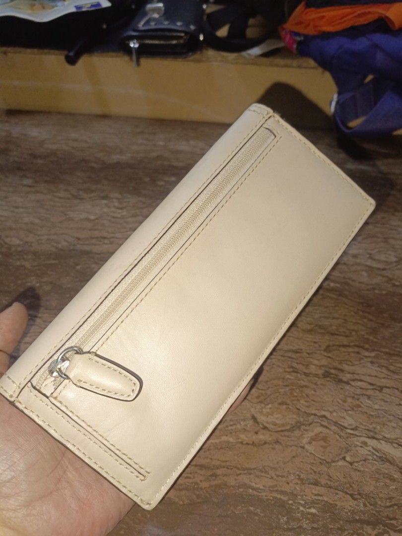 Coach (Category: Luxury Bags & Wallets) located in San Pedro. Submitted by elevens_online_thrift_shop (Listing ID 1455729946, Image 3). Description: Product Identification * Product Type: Coach Women's Leather Long Flap / Soft Wallet (Slim Envelope Wallet) * Brand: Coach New York * Material & Color: Cream/Chalk smooth leather exterior with light pink interior contrast, brown edge painting, silver-tone hardware (snap closure and back zip coin pock