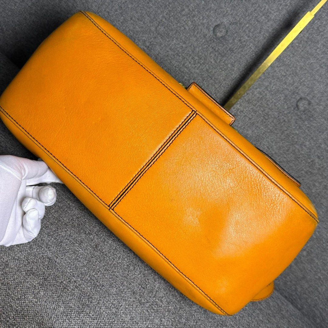 Fendi Orange Leather Baguette Bag (Category: Luxury Bags & Wallets) located in Madrid. Submitted by jhunaceee (Listing ID 1455814075, Image 3). Description: - Authentic orange Fendi baguette bag - Iconic Fendi logo buckle - Interior with signature striped lining - Includes original Fendi dust bag - Versatile for daily use or evening events.