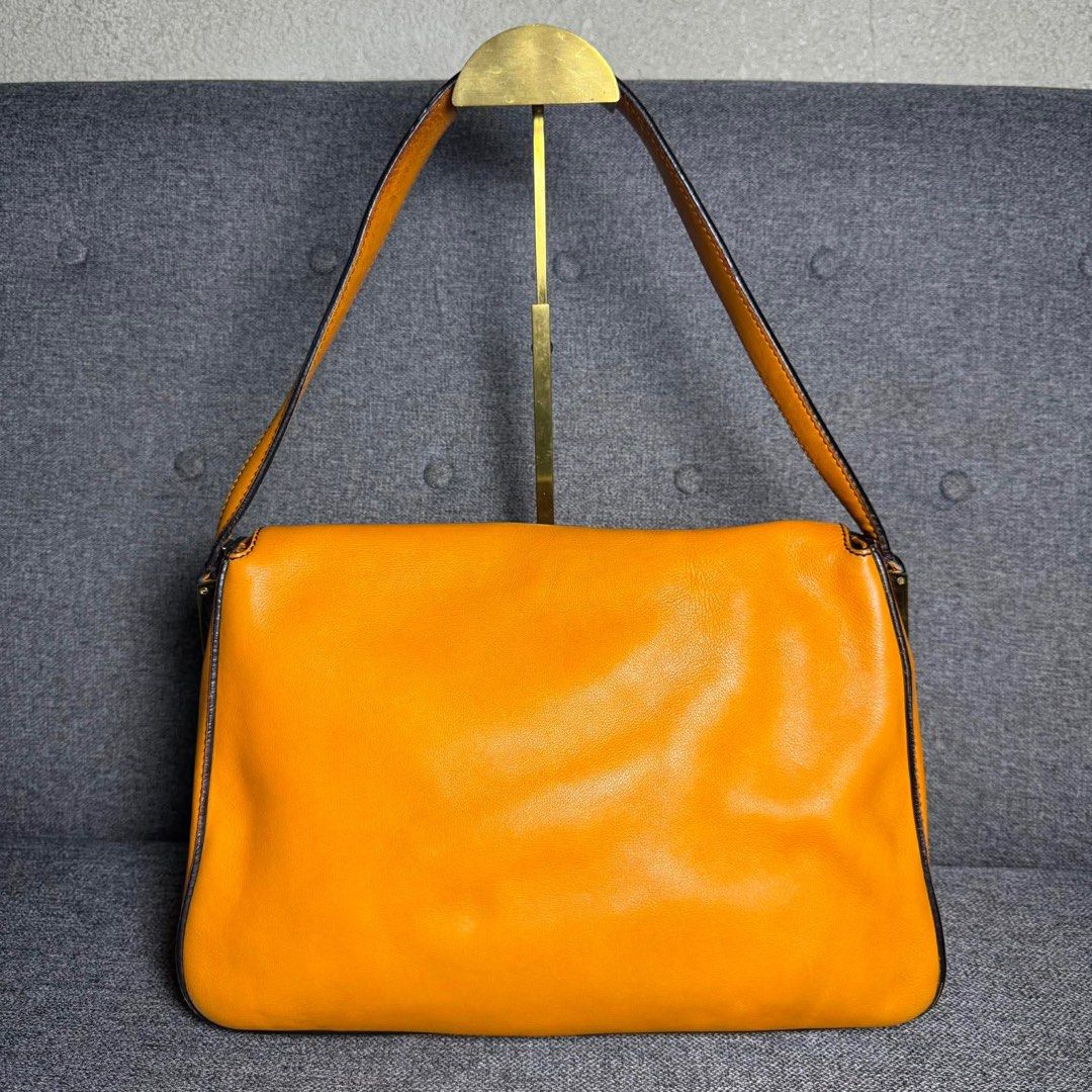 Fendi Orange Leather Baguette Bag (Category: Luxury Bags & Wallets) located in Madrid. Submitted by jhunaceee (Listing ID 1455814075, Image 2). Description: - Authentic orange Fendi baguette bag - Iconic Fendi logo buckle - Interior with signature striped lining - Includes original Fendi dust bag - Versatile for daily use or evening events.