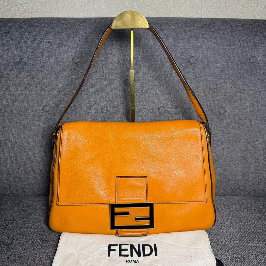 Fendi Orange Leather Baguette Bag (Category: Luxury Bags & Wallets) located in Madrid. Submitted by jhunaceee (Listing ID 1455814075, Image 1). Description: - Authentic orange Fendi baguette bag - Iconic Fendi logo buckle - Interior with signature striped lining - Includes original Fendi dust bag - Versatile for daily use or evening events.