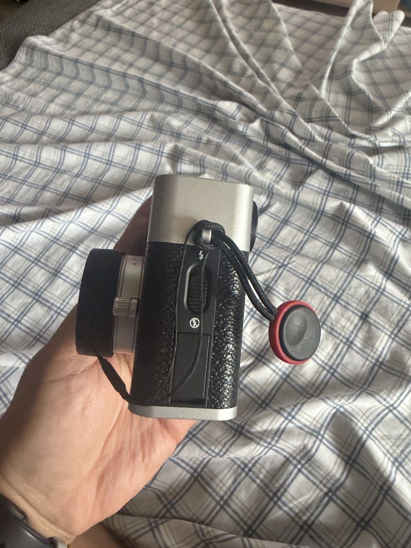 Fujifilm X-Half Digital Camera Silver/Black (Category: Cameras) located in San Nicolas. Submitted by kaesacoco (Listing ID 1455742381, Image 2). Description: Fujifilm X-Half camera in silver and black. Comes with lens cap and wrist straps. Great for stills and movies. The screen shows settings like ISO, aperture, and shutter speed. Ready for your next shot..