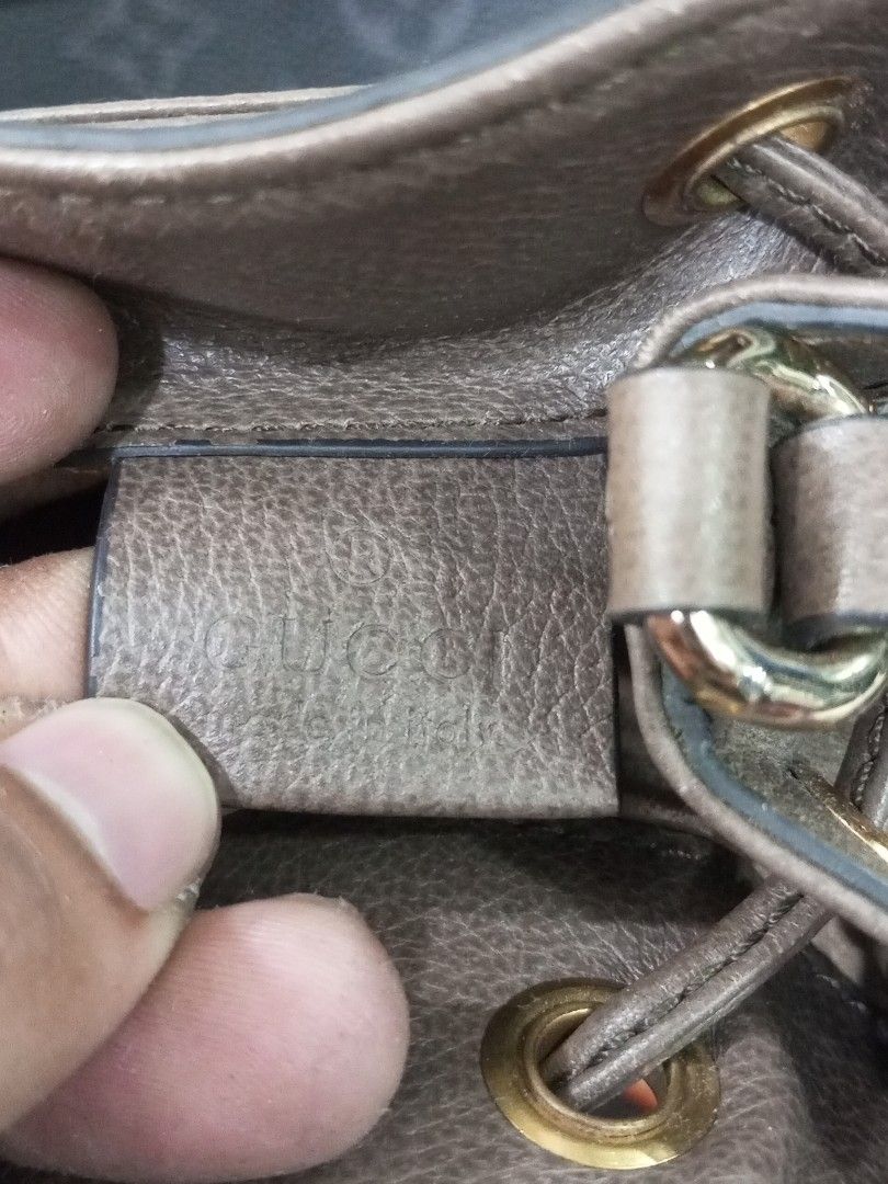 Gucci Monogram GG Supreme Canvas Bucket Bag (Category: Luxury Bags & Wallets) located in Bacolod City. Submitted by exequelgra46775 (Listing ID 1455762695, Image 2). Description: - Authentic Gucci bucket bag - Classic GG monogram canvas - Brown leather trim - Signature green and red stripe detail - Drawstring closure - Adjustable shoulder strap - Interior shows some signs of wear - Serial number visible in photos.