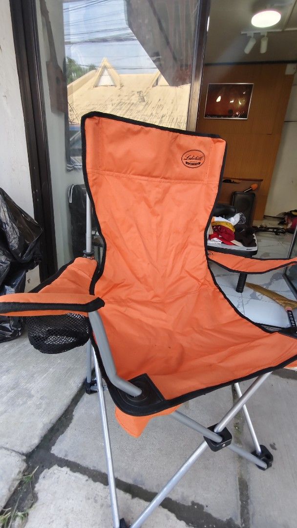 Lakehill Orange Folding Camping Chair (Category: Hiking & Camping) located in Bulacan. Submitted by babz30261 (Listing ID 1455733670, Image 2). Description: - Orange folding chair from Lakehill - Ideal for camping and outdoor events - Sturdy metal frame for durability - Convenient side cup holder - Folds easily for transport and storage - Ready for your next adventure!.