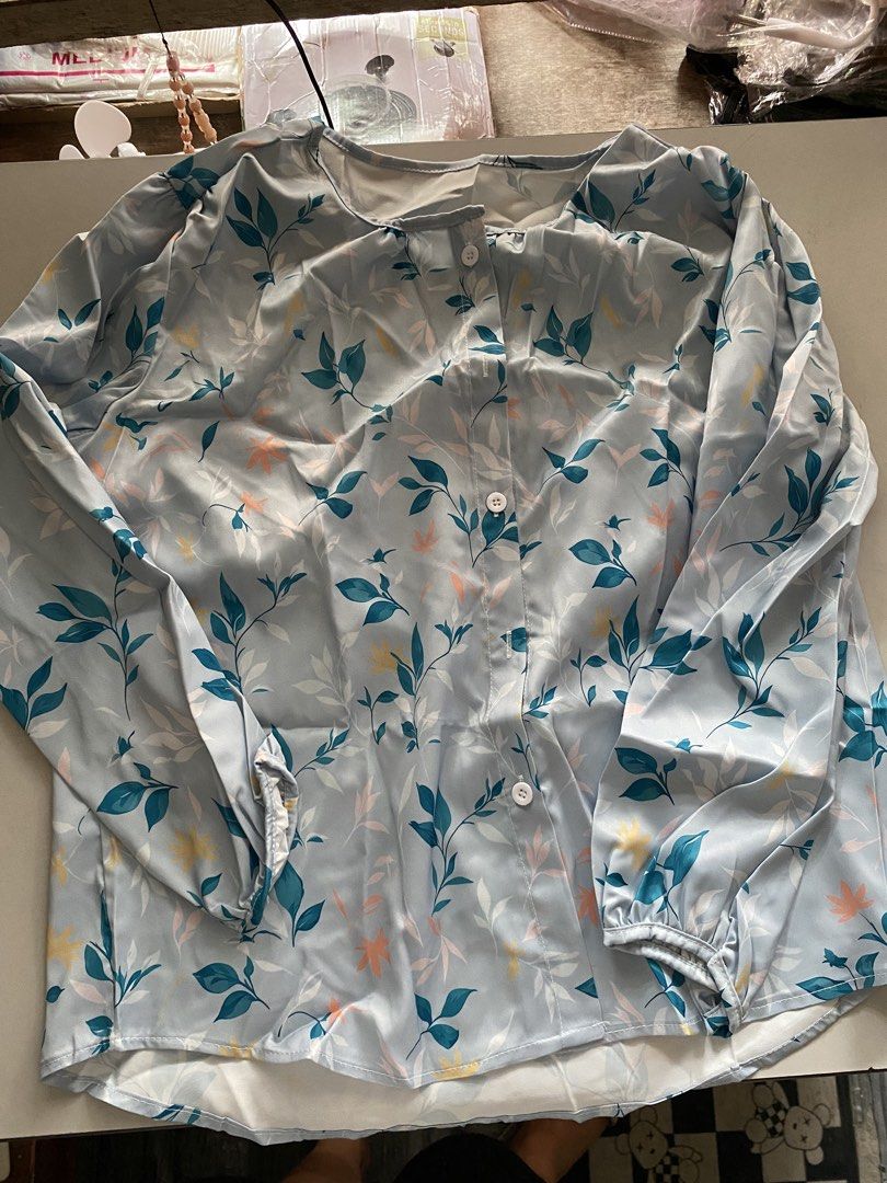 Light Blue Floral Long Sleeve Button Up Blouse (Category: Blouses) located in Taguig. Submitted by msifycart (Listing ID 1455720913, Image 3). Description: - Light blue blouse with a pretty floral print - Features long puff sleeves with elastic cuffs - Button-up front - Lightweight material, ideal for warmer weather or layering - Chic and stylish design.