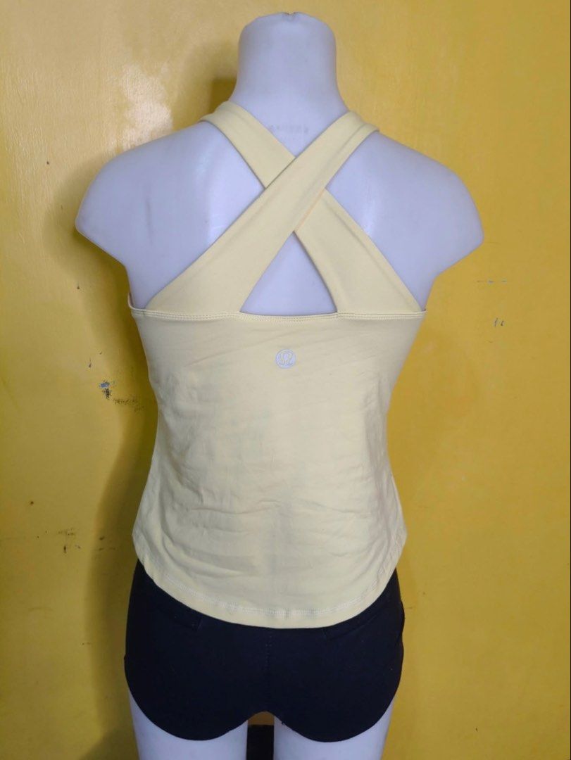 Lululemon Yellow Criss-Cross Back Tank Top (Category: Activewear) located in San Narciso. Submitted by angels.attic21 (Listing ID 1455700197, Image 2). Description: - Vibrant yellow Lululemon tank top - medium-large ⚠️authenticity not guaranteed - Features a chic criss-cross detail on the back - Classic racerback style for freedom of movement - Made from soft, comfortable fabric - Ideal for workouts, yoga, or casual everyday styling.