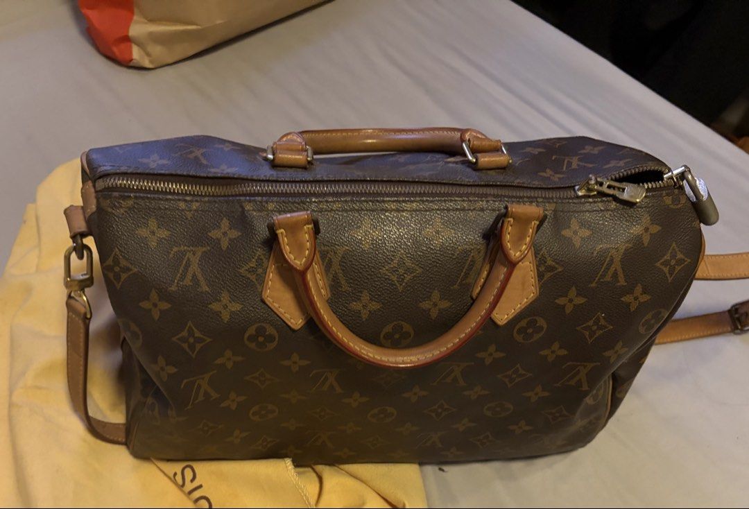 LV Monogram Speedy 35 Boston Bag (Category: Luxury Bags & Wallets) located in Apalit. Submitted by bbiaaa (Listing ID 1455725836, Image 1). Description: AUTHENTIC 💯 slightly nego * monogram canvas body with vachetta leather trim * rolled vachetta leather handles * top zip closure * interior slip pocket * brown * serial number: BU2101 * inclusions: padlock (no keys), dust bag * condition: FAIR. this previously owned and used item is in fair condi