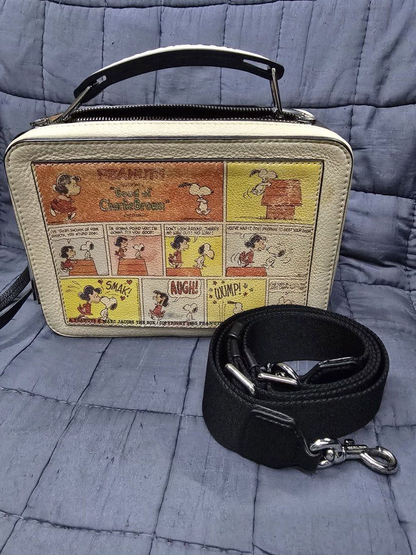 MARC JACOBS x PEANUTS Box Bag (Category: Shoulder Bags) located in Manila. Submitted by eightch (Listing ID 1455839809, Image 2). Description: MARC JACOBS x PEANUTS ‘Good Ol’ Charlie Brown & Snoopy Box Bag • 101% Authentic • Bought in Japan • Original price: ¥42,800 • Dimension: 23cm L x 16cm H; 4cm Handle; 128cm Strap • The design itself has a stained effect/distressed look. • With dust bag (light stains) • With minimal scratches on the metal ha