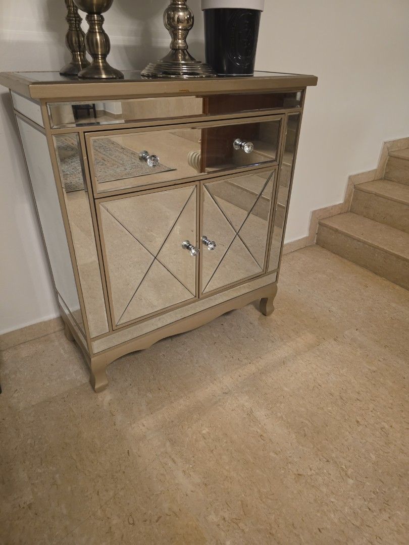Mirrored Cabinet with Crystal Knobs (Category: Shelves, Cabinets & Racks) located in Singapore. Submitted by furniturensuch (Listing ID 1455813274, Image 1). Description: - Mirrored cabinet with eye-catching diamond pattern on doors - Elegant crystal knobs for easy opening - Light wood frame complements any decor - Ideal for stylish storage solutions - Adds a touch of glam to any room - Approximate dimensions: [80 (W) by 87 (H) by 35(D)] Self-col