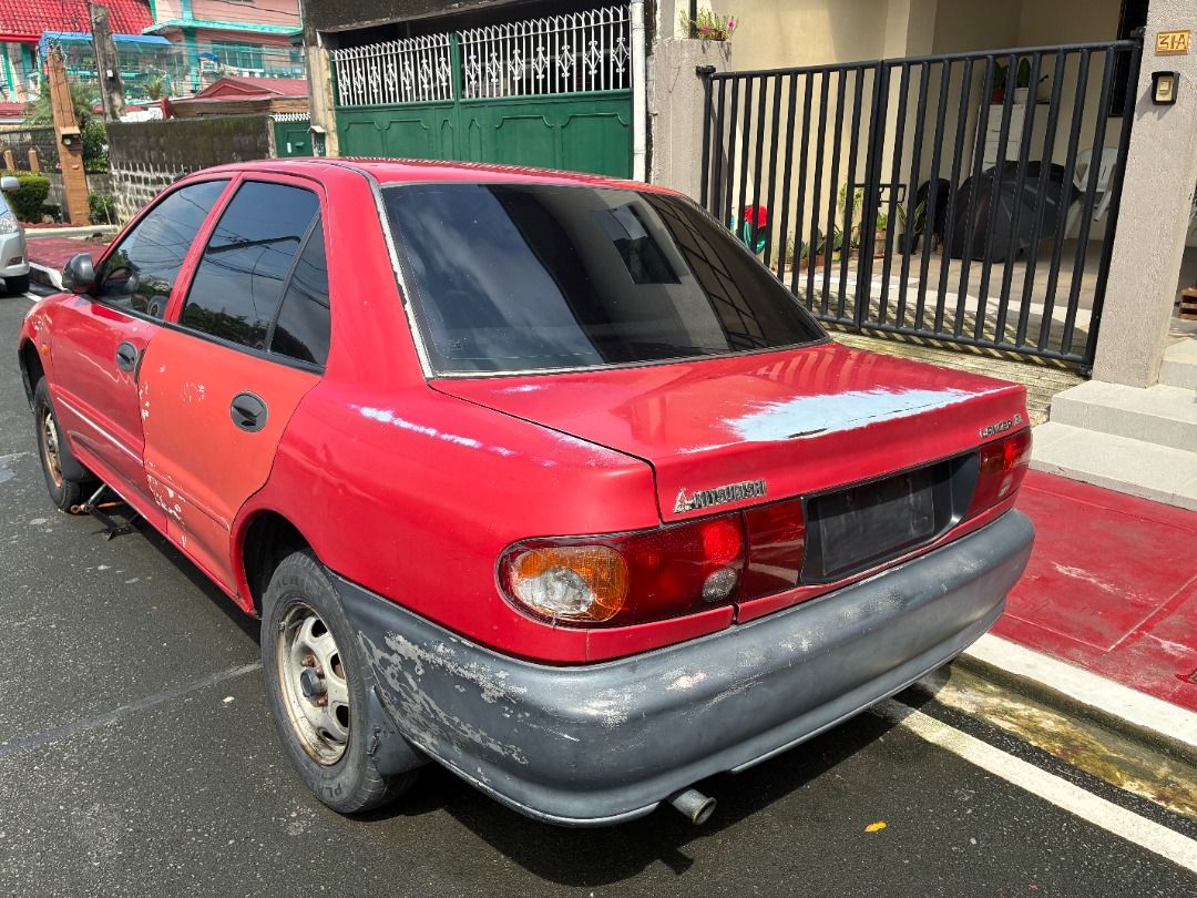 Mitsubishi Lancer EL Manual (Category: Used Cars) located in Quezon City. Submitted by jiggyboy11 (Listing ID 1450740931, Image 3). Description: Selling unit as-is For scrap Not eligible for transfer of ownership (owner deceased) No papers Not in running condition Needs engine overhaul due to broken timing belt Broken compressor Broken rear shock absorber Manual transmission Carburetor type Location: Near OLPH Parish, Project 8, Quezon City.
