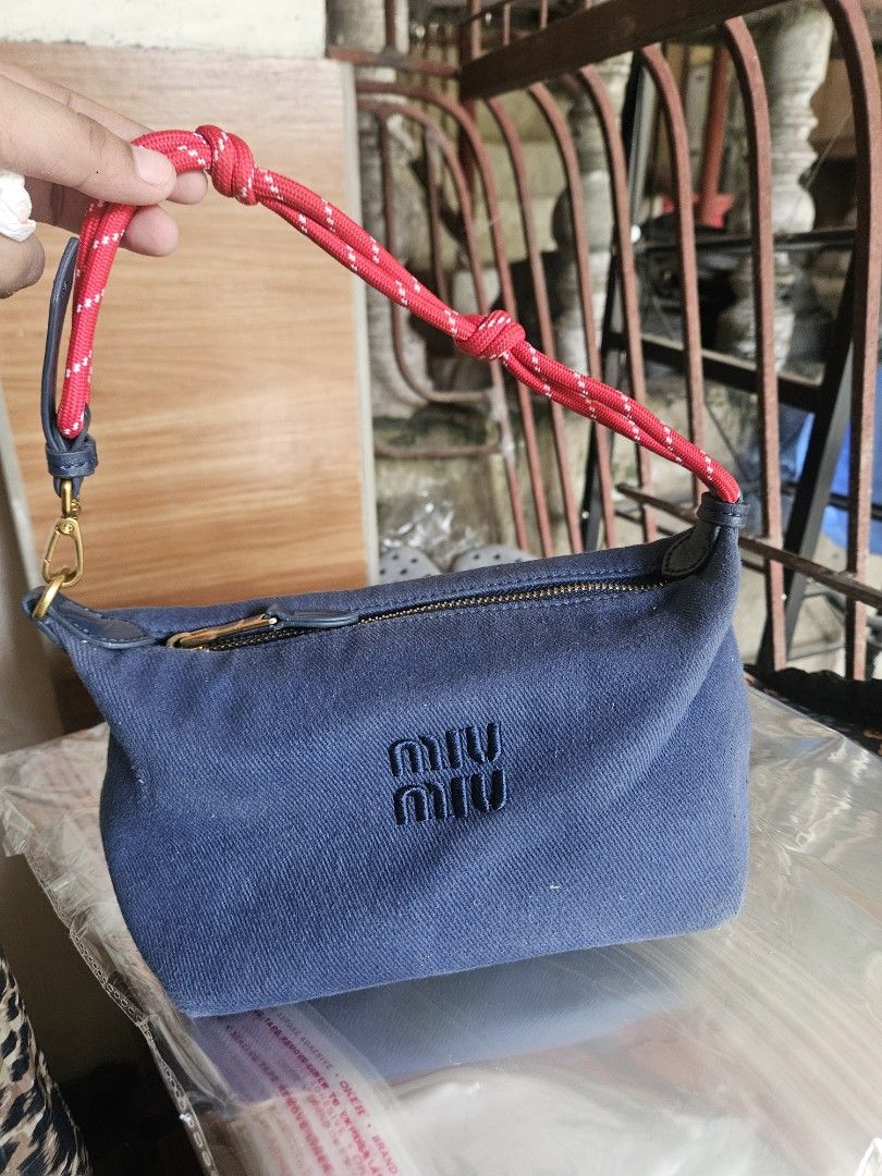 Miu Miu Blue Denim Pouch with Red Rope Strap (Category: Luxury Bags & Wallets) located in Manila. Submitted by clayd052 (Listing ID 1455846433, Image 1). Description: - Features embroidered Miu Miu logo on the front - Comes with a red rope strap with white speckles - Secure zipper closure - Ideal for carrying daily essentials NGA.