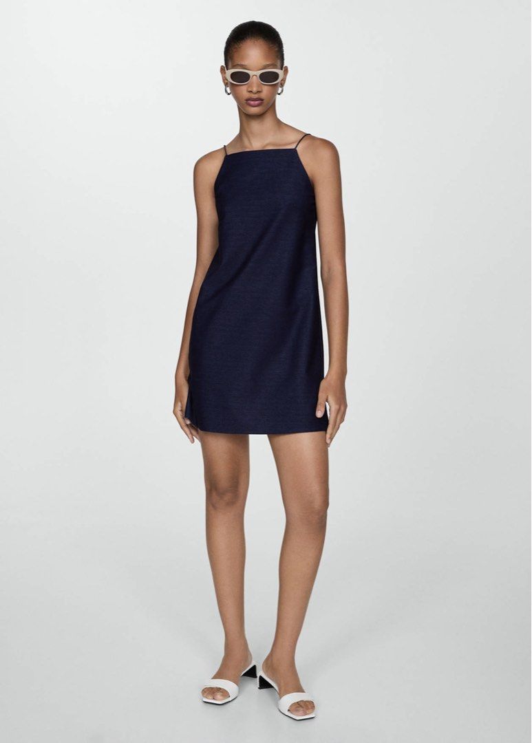 MNG Short Strap Dress (Category: Dresses) located in Pasig City. Submitted by ninifinds (Listing ID 1455818386, Image 2). Description: Elevate your minimal daily wardrobe with this classic navy blue slip-style mini dress from Mango (MNG). It features a highly flattering square neckline, ultra-thin spaghetti straps, and a clean, straight-cut shift silhouette. Crafted from a comfortable, breathable fabric that drapes effortlessly for warm-weather s