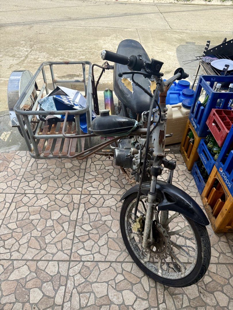 Motorcycle with Sidecar for Sale (Category: Motorbikes for Sale) located in Manila. Submitted by fastwolf-e015 (Listing ID 1455735117, Image 1). Description: Selling a motorcycle with a sidecar. The sidecar is made of metal. The motorcycle has a black seat with some wear. Some rust is visible on the sidecar frame. Ready for a new owner..