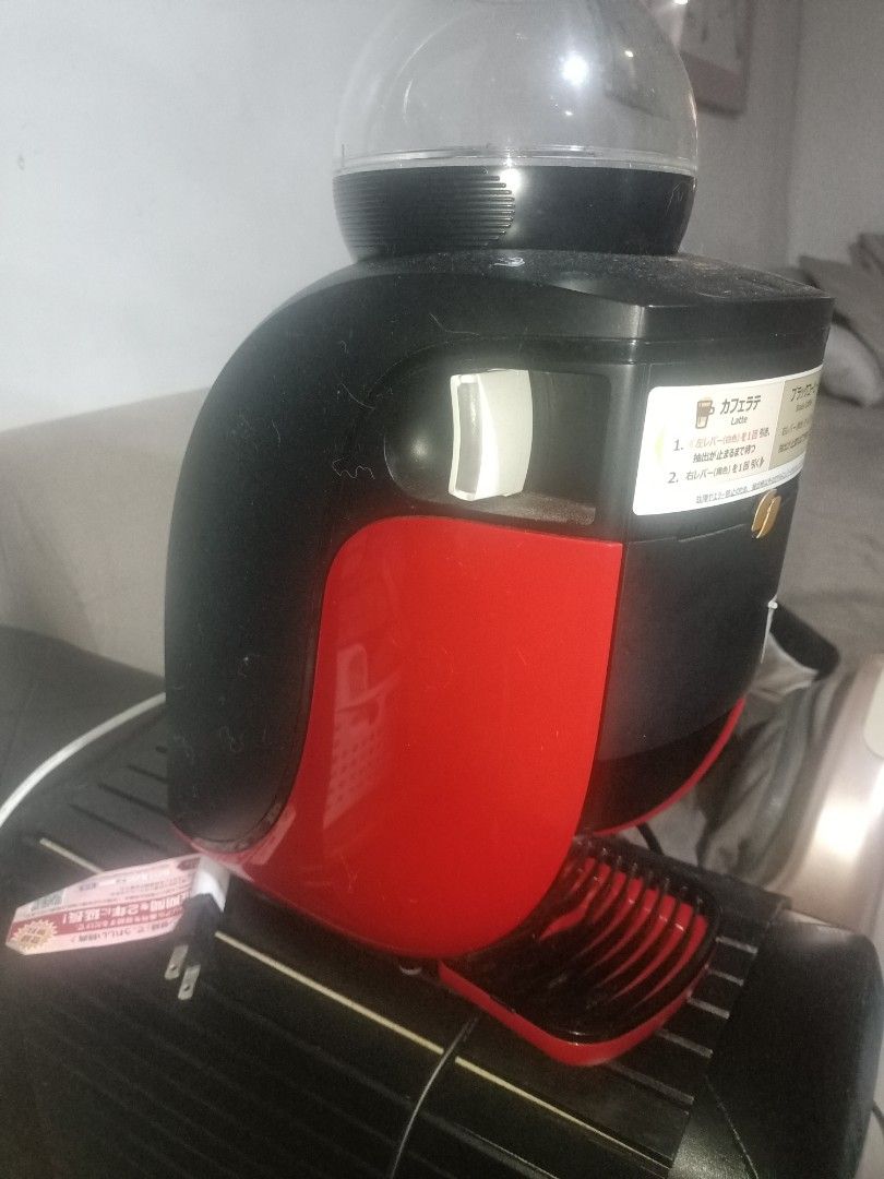 Nescafe Dolce Gusto Coffee Maker & TESCOM Foot Massager (Category: Coffee Machines & Makers) located in Cavite. Submitted by gregorypagnes08 (Listing ID 1455767027, Image 3). Description: - Nescafe Dolce Gusto coffee maker: Black and red with clear water tank. - TESCOM foot massager: Gold and black with multiple massage settings. - Both items are fully functional and ready for use. - Ideal for your daily coffee fix and evening relaxation..