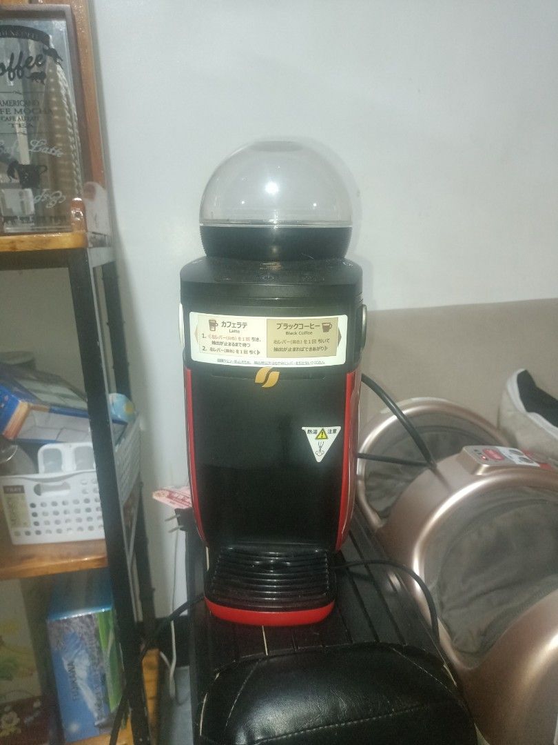 Nescafe Dolce Gusto Coffee Maker & TESCOM Foot Massager (Category: Coffee Machines & Makers) located in Cavite. Submitted by gregorypagnes08 (Listing ID 1455767027, Image 1). Description: - Nescafe Dolce Gusto coffee maker: Black and red with clear water tank. - TESCOM foot massager: Gold and black with multiple massage settings. - Both items are fully functional and ready for use. - Ideal for your daily coffee fix and evening relaxation..