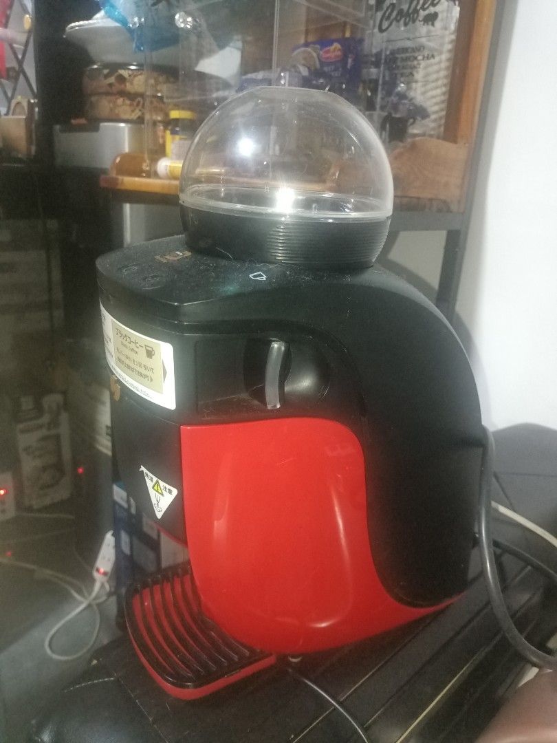 Nescafe Dolce Gusto Coffee Maker & TESCOM Foot Massager (Category: Coffee Machines & Makers) located in Cavite. Submitted by gregorypagnes08 (Listing ID 1455767027, Image 2). Description: - Nescafe Dolce Gusto coffee maker: Black and red with clear water tank. - TESCOM foot massager: Gold and black with multiple massage settings. - Both items are fully functional and ready for use. - Ideal for your daily coffee fix and evening relaxation..