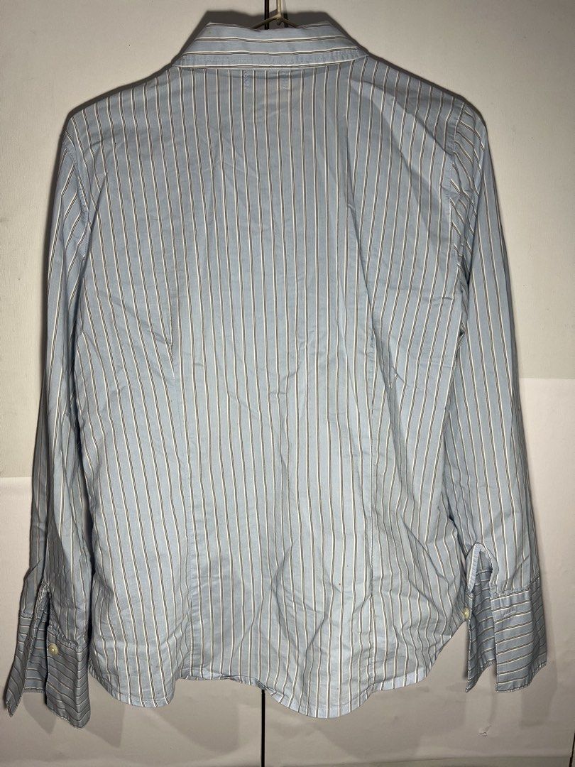 Old Navy Blue Striped Button-Up Shirt Size M (Category: Shirts) located in Quezon City. Submitted by ishaan1423 (Listing ID 1455706414, Image 2). Description: - Old Navy light blue button-up shirt - Features thin white and grey stripes - Long sleeves with button cuffs - Classic collared design - Made in Indonesia - Versatile for work or casual outfits.