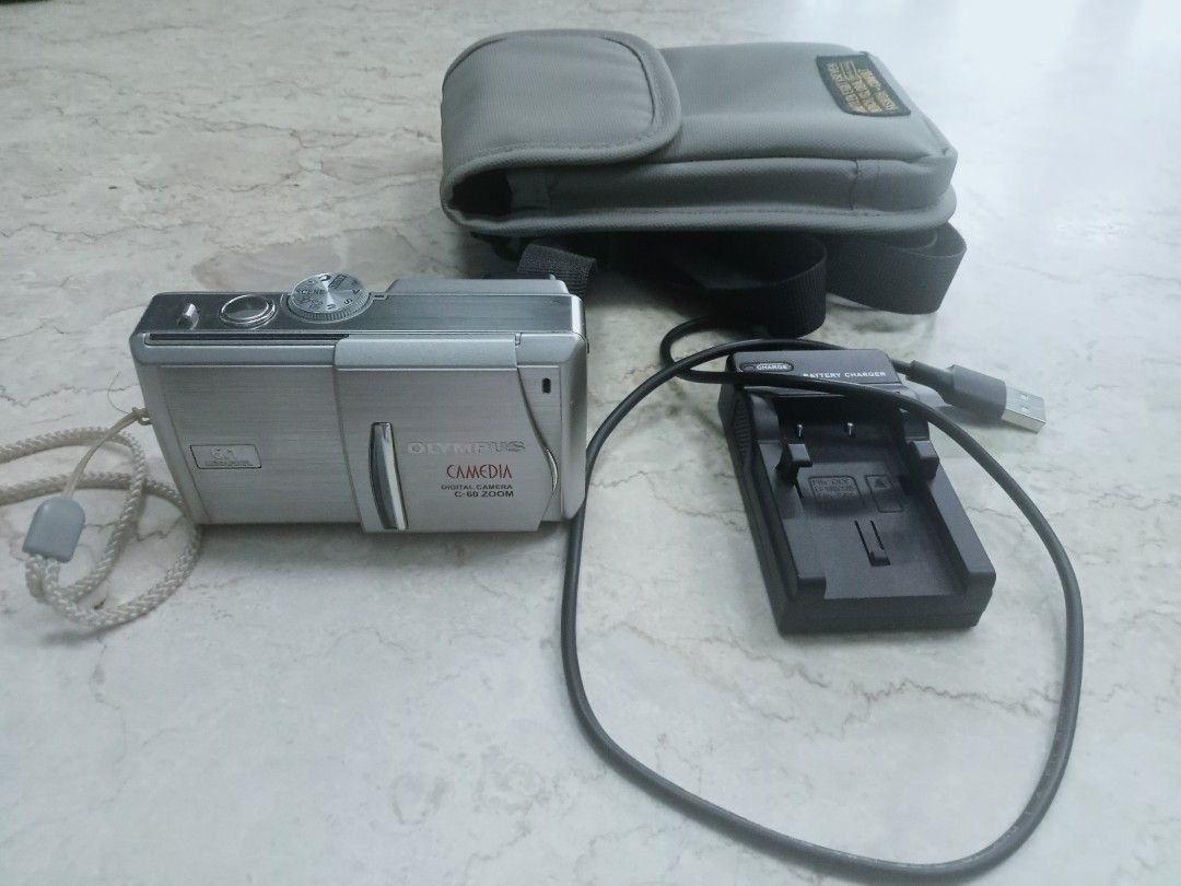 Olympus C-60 (Category: Cameras) located in Makati City. Submitted by topitops (Listing ID 1455704892, Image 2). Description: 6.1 MP stored in drybox when not in use comes with charger for LI 10B/12B camera pouch.