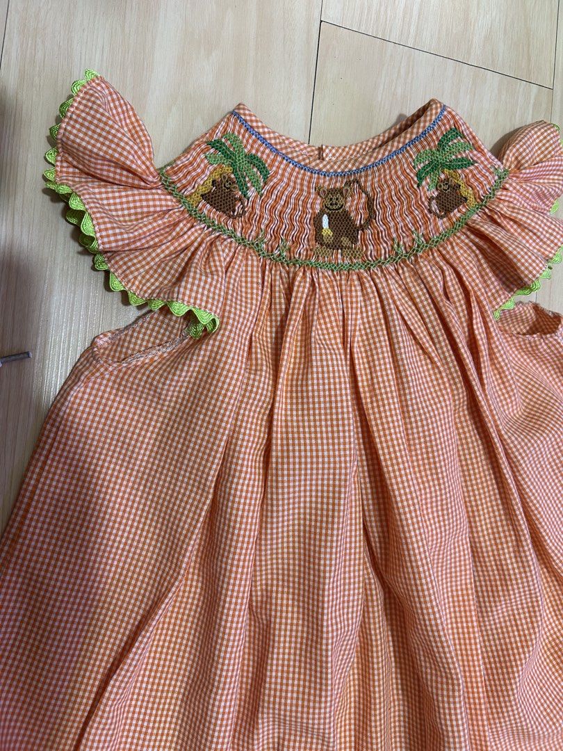Orange Gingham Smocked Dress with Monkey Embroidery (Category: Babies & Kids Fashion) located in Manila. Submitted by jessdzn (Listing ID 1455824653, Image 2). Description: - Cute orange and white gingham dress - Smocked neckline with embroidered monkeys and palm trees - Ruffled sleeves with green trim - Buttons down the back - Perfect for your little one!.