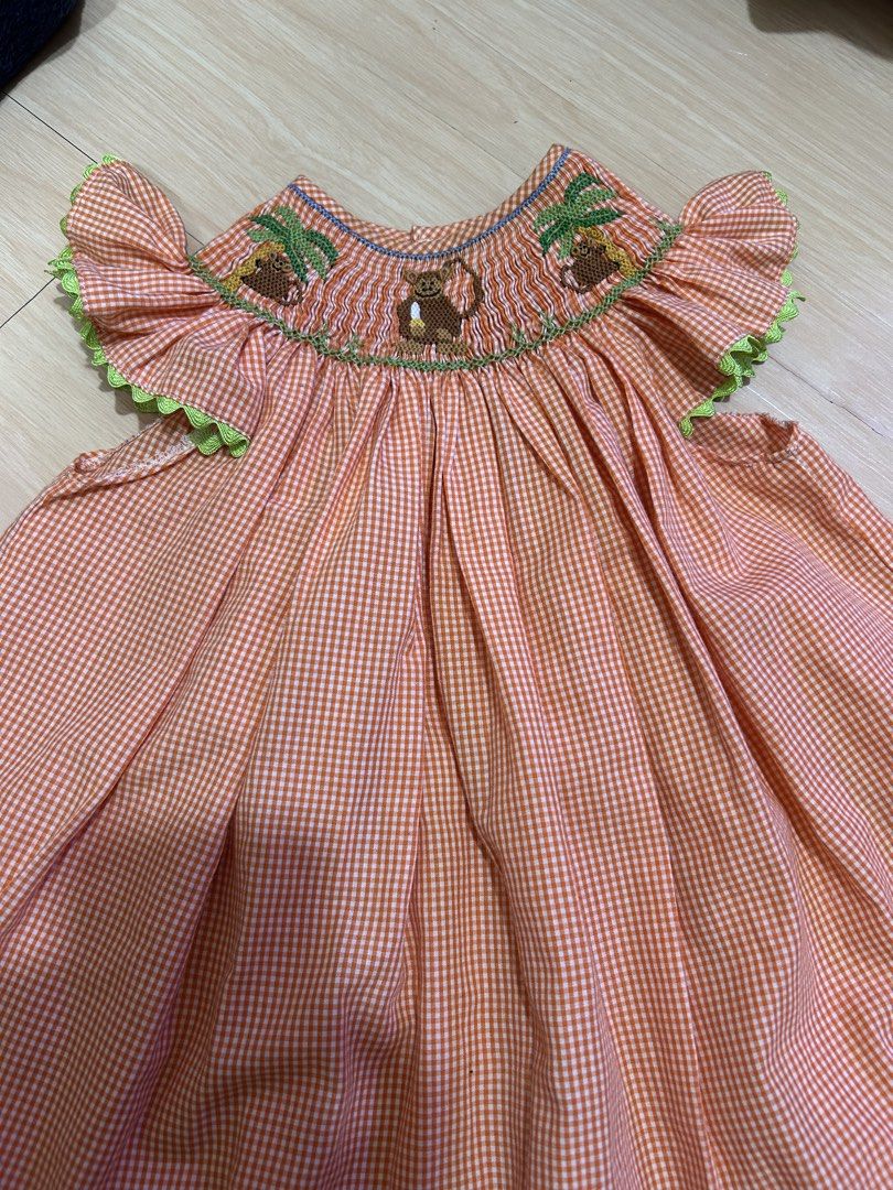Orange Gingham Smocked Dress with Monkey Embroidery (Category: Babies & Kids Fashion) located in Manila. Submitted by jessdzn (Listing ID 1455824653, Image 1). Description: - Cute orange and white gingham dress - Smocked neckline with embroidered monkeys and palm trees - Ruffled sleeves with green trim - Buttons down the back - Perfect for your little one!.