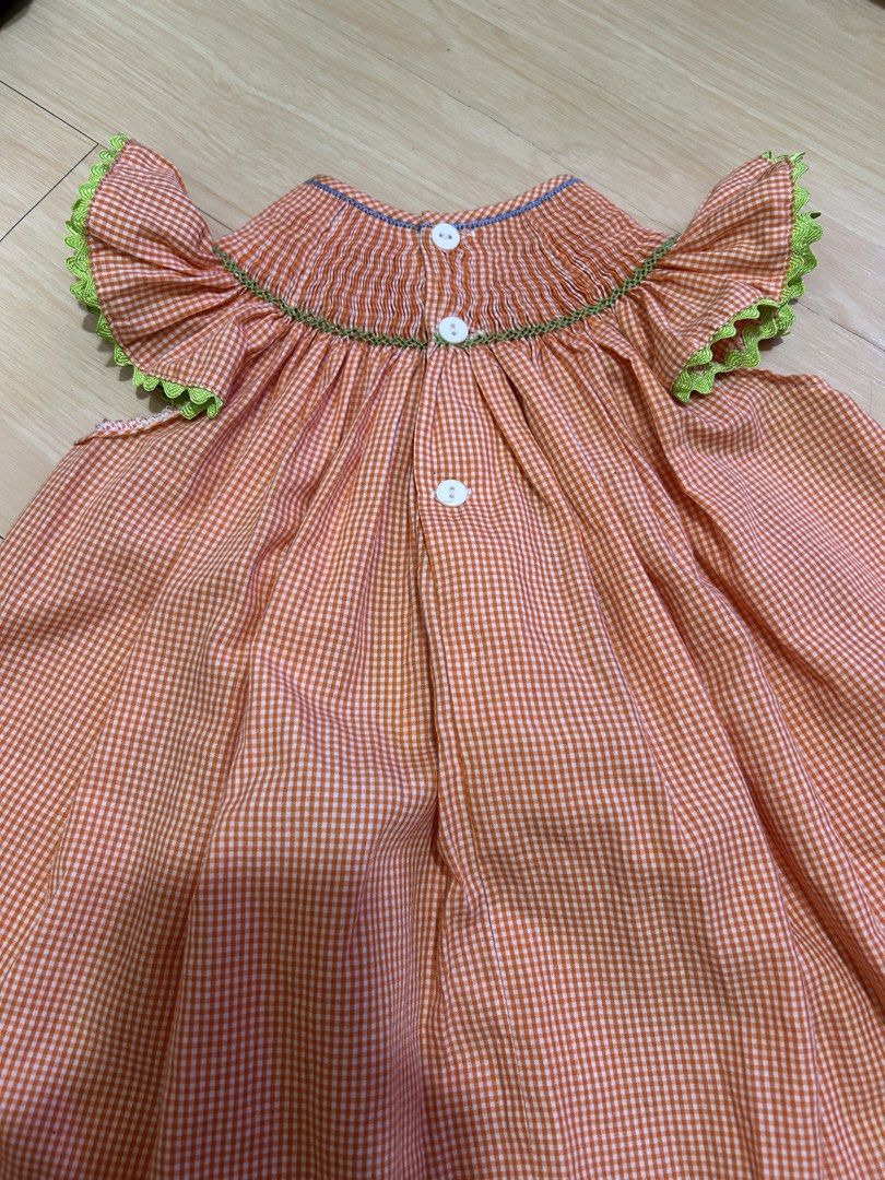Orange Gingham Smocked Dress with Monkey Embroidery (Category: Babies & Kids Fashion) located in Manila. Submitted by jessdzn (Listing ID 1455824653, Image 3). Description: - Cute orange and white gingham dress - Smocked neckline with embroidered monkeys and palm trees - Ruffled sleeves with green trim - Buttons down the back - Perfect for your little one!.