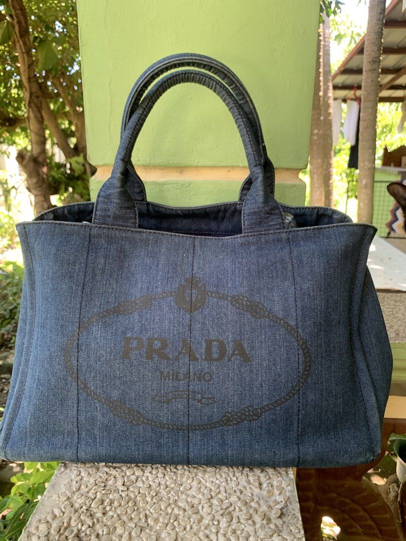 PRADA canapa canvass (Category: Luxury Bags & Wallets) located in San Fabian. Submitted by dhangkie86834 (Listing ID 1306261160, Image 1). Description: Prada Canapa In very good condition Denim canvass gold harwares No flaws in very good condition Color rate is 9/10 Large size.