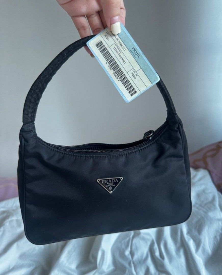 Prada Nylon Shoulder Bag❗️SOLD❗️ (Category: Luxury Bags & Wallets) located in Manila. Submitted by sharmained70134 (Listing ID 1455782263, Image 3). Description: - Authentic Prada Bag - Color: Black - Material: Nylon - Features: Classic triangle logo, zipper closure - Interior Detail: Small tag with '19' - Origin: Made in Italy - Includes: Original tag.
