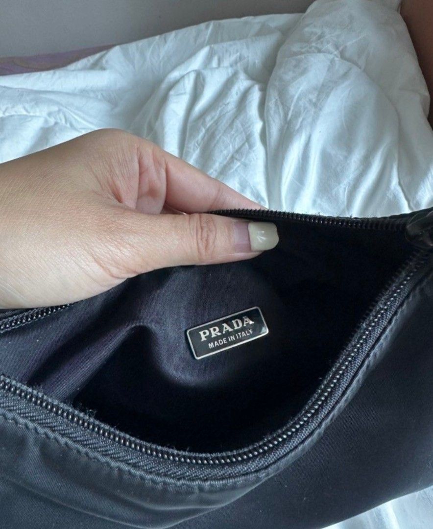 Prada Nylon Shoulder Bag❗️SOLD❗️ (Category: Luxury Bags & Wallets) located in Manila. Submitted by sharmained70134 (Listing ID 1455782263, Image 2). Description: - Authentic Prada Bag - Color: Black - Material: Nylon - Features: Classic triangle logo, zipper closure - Interior Detail: Small tag with '19' - Origin: Made in Italy - Includes: Original tag.