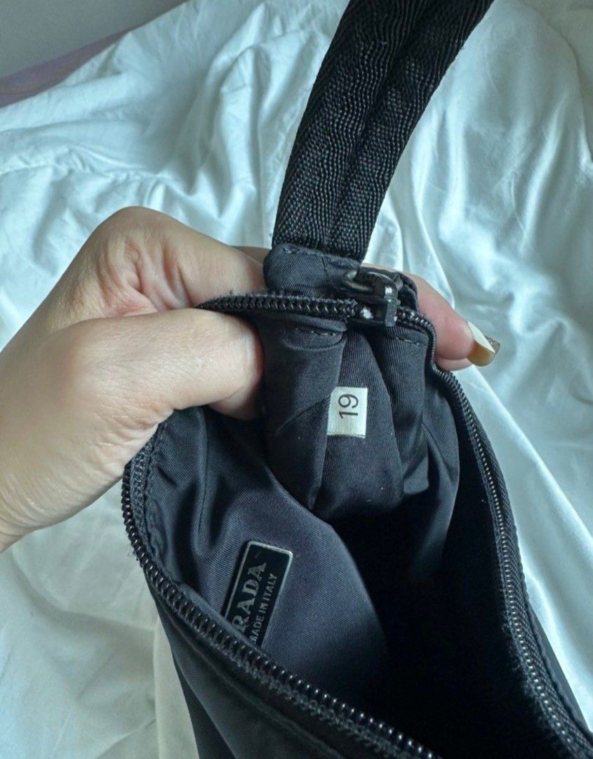 Prada Nylon Shoulder Bag❗️SOLD❗️ (Category: Luxury Bags & Wallets) located in Manila. Submitted by sharmained70134 (Listing ID 1455782263, Image 1). Description: - Authentic Prada Bag - Color: Black - Material: Nylon - Features: Classic triangle logo, zipper closure - Interior Detail: Small tag with '19' - Origin: Made in Italy - Includes: Original tag.