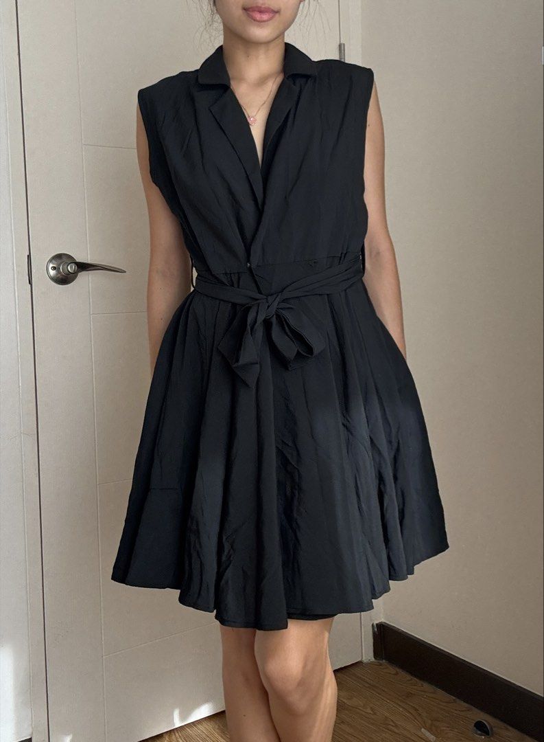 Sleeveless Black Collared Wrap Dress with Belt (Category: Dresses) located in Mandaluyong City. Submitted by anj_declutters (Listing ID 1455744012, Image 1). Description: - Sleeveless black dress - Collared neckline - Wrap front design - Includes matching fabric belt - Flared, pleated skirt - Ideal for smart casual or work occasions - Versatile for dressing up or down.