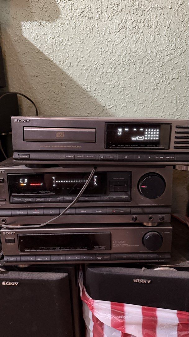 Sony CD Player, Amplifier, and Cassette Deck (Category: Soundbars, Speakers & Amplifiers) located in Manila. Submitted by purestorm_7606e4 (Listing ID 1455768272, Image 2). Description: - Complete vintage Sony audio system stacked together. - Features a HIGH DENSITY LINEAR CONVERTER DIRECT DIGITAL SYNC CD player. - Amplifier with display showing CD and SURROUND SOUND capabilities. - Includes a Sony LBT-D505 cassette deck. - Ideal for creating a c