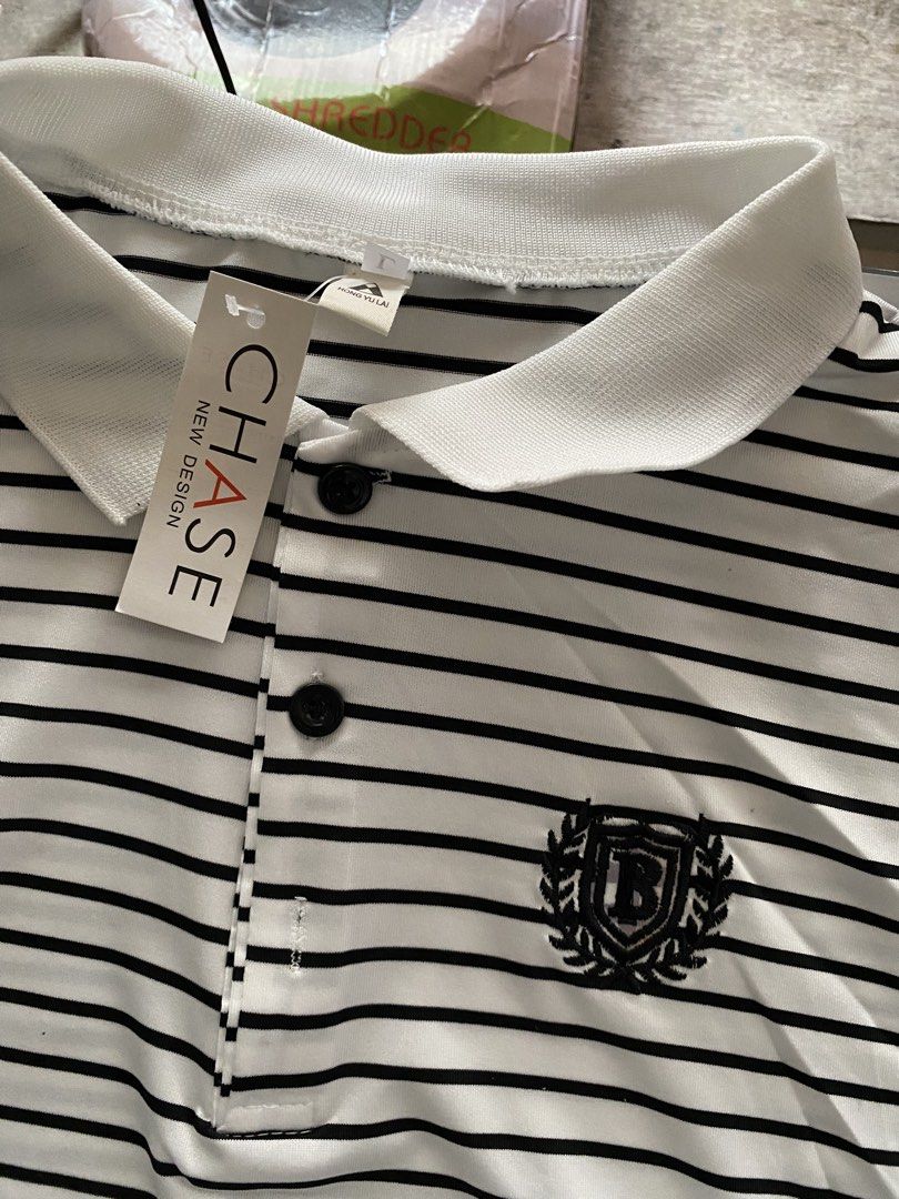 Striped Polo Shirt with Emblem (Category: Tshirts & Polo Shirts ) located in Taguig. Submitted by msifycart (Listing ID 1455720480, Image 2). Description: - Classic black and white striped polo shirt - Short sleeves - Button-up neckline - Small emblem on the chest - Contrasting collar and cuffs - Ideal for a smart casual look.