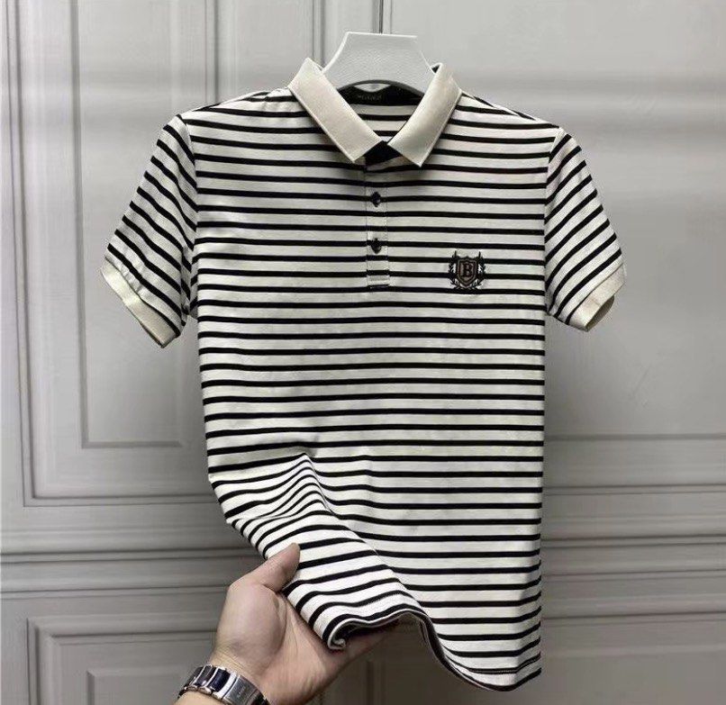 Striped Polo Shirt with Emblem (Category: Tshirts & Polo Shirts ) located in Taguig. Submitted by msifycart (Listing ID 1455720480, Image 1). Description: - Classic black and white striped polo shirt - Short sleeves - Button-up neckline - Small emblem on the chest - Contrasting collar and cuffs - Ideal for a smart casual look.
