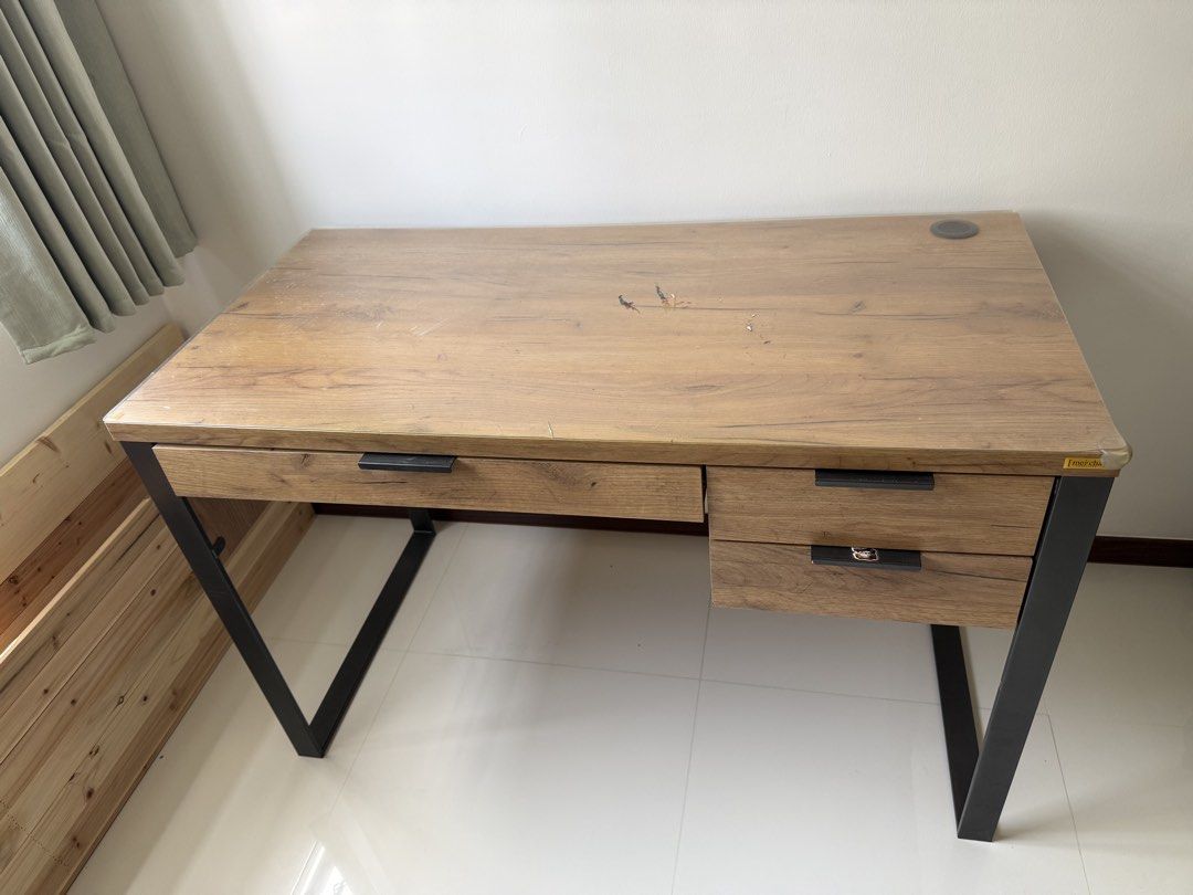 Study table (Category: Other Home Furniture) located in Singapore. Submitted by mimimi6381 (Listing ID 1455697461, Image 1). Description: Wooden desk with black metal legs. Features 2 drawers and a wood grain top with a cable cutout. Perfect for home office/study..