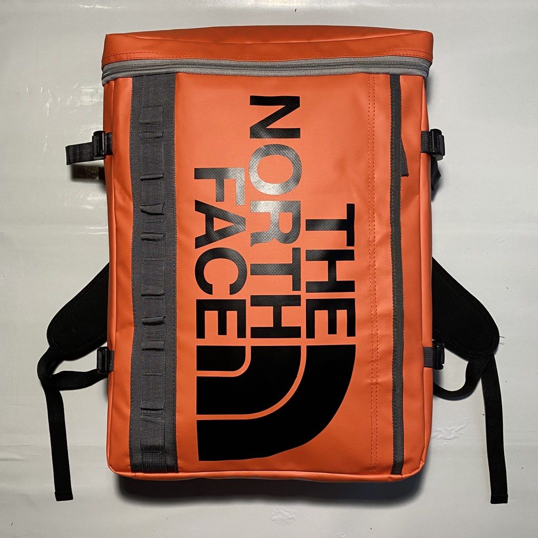 The North Face Base Camp Duffel Backpack Orange (Category: Backpacks) located in Manila. Submitted by ashiee111 (Listing ID 1455837841, Image 1). Description: - Authentic Orange The North Face backpack - Distinctive boxy shape with prominent front logo - Features multiple straps and buckles for adjustable and secure fit - Main compartment opens wide for easy packing and access - Includes a convenient mesh pocket inside for organization - Perfect 